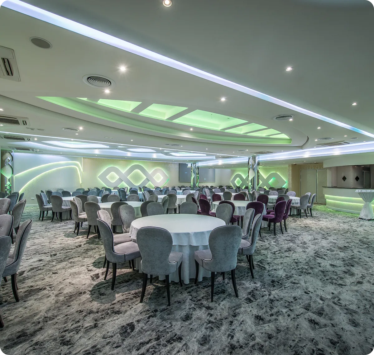 Modern banquet hall with round tables.